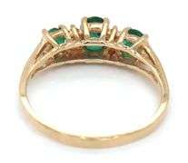 10kt Yellow gold oval emerald and diamond accent 3 stone ring