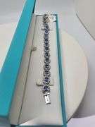 A true statement of elegance of Tanzanite and diamond Bracelet in Silver – GGA Certified. Set in lus