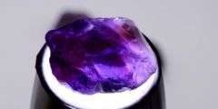 Deep color in this 69.67ct uncut untreated Amethyst set