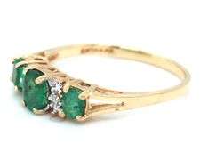 10kt Yellow gold oval emerald and diamond accent 3 stone ring
