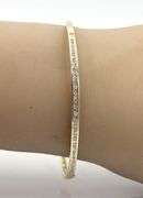 10kt Yellow gold 0.55ctw round brilliant cut and baguette bangle bracelet