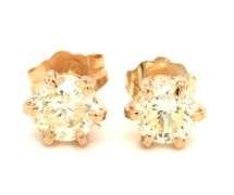 One pair of 14kt yellow gold 1.03ctw round brilliant cut diamond stud earrings