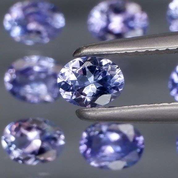 Heavy flashing 2.92ct oval cut Tanzanite set