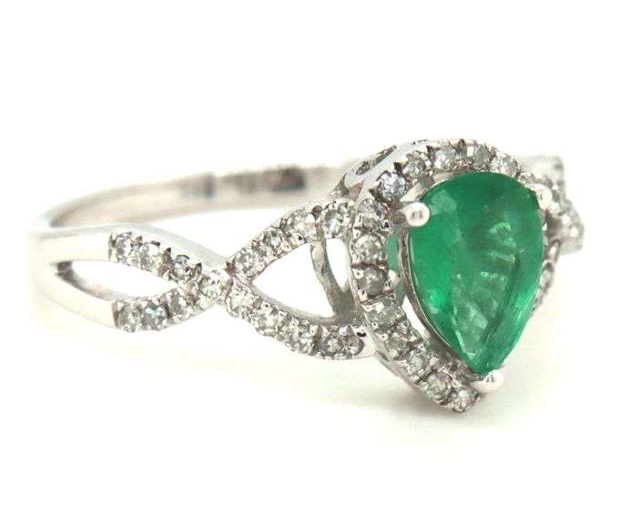 14kt White gold 0.65ct pear shaped emerald and 0.25ctw diamond infinity ring