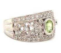 14kt White gold bezel set oval peridot and diamond flower Inspired milgrain ring