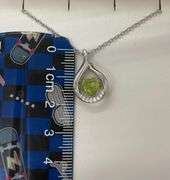 Beautiful sterling silver with center genuine natural dancing peridot with moissanite side stone pen