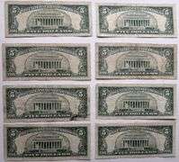 Eight $5 1963 Red Seal US Notes.