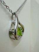 Beautiful sterling silver with center genuine natural dancing peridot with moissanite side stone pen
