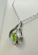 Beautiful sterling silver with center genuine natural dancing peridot with moissanite side stone pen