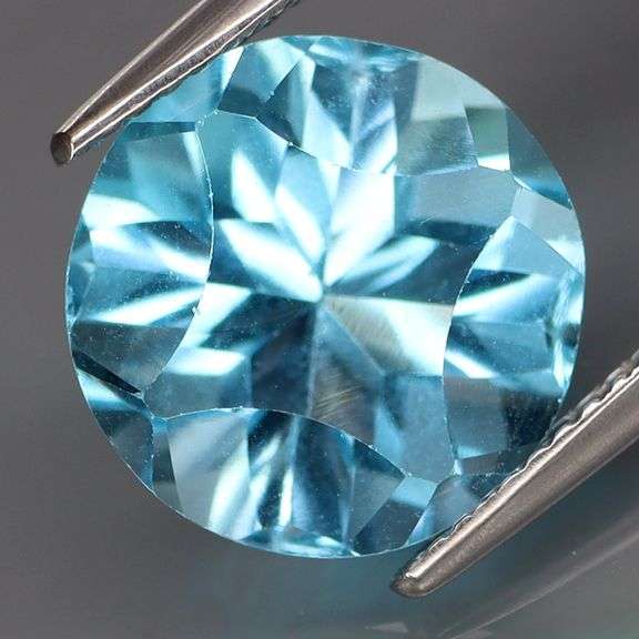 It’s an 8.46ct fully concave cut Topaz solitaire in Swiss blue!