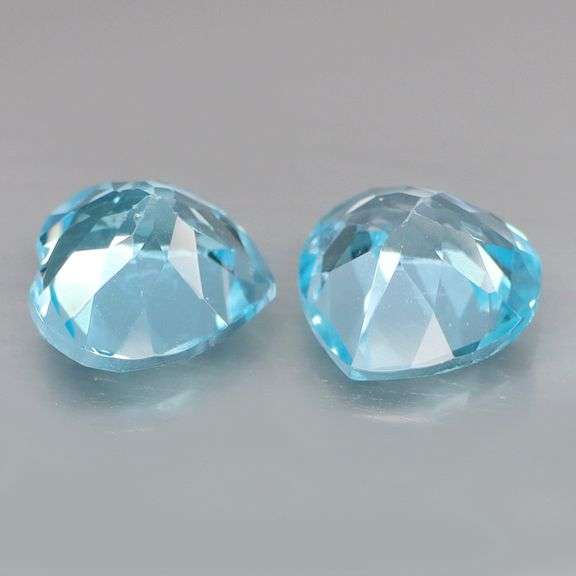Dazzling 9.45ct vivid blue heart cut Topaz pair