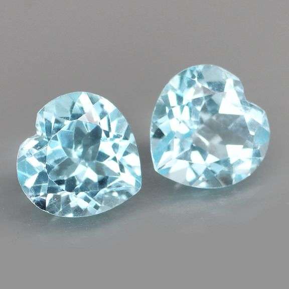 Dazzling 9.45ct vivid blue heart cut Topaz pair