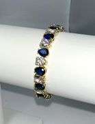 Stunning Yellow Gold Plated 32.5 Ctw Simulated Sapphire and CZ Tennis Bracelet