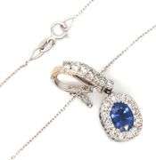 14kt White gold blue sapphire and diamond halo and sapphire under halo enhancer pendant on chain
