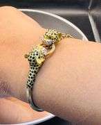 VINTAGE 1980s 18K GOLD LEOPARD BANGLE WITH DIAMONDS & RUBIES