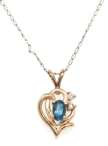 Set of 14kt Yellow gold oval blue topaz and diamond accent pendant on chain with matching earrings