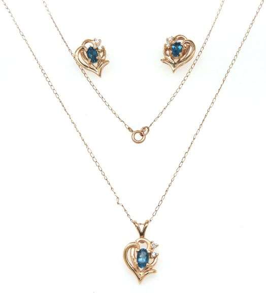 Set of 14kt Yellow gold oval blue topaz and diamond accent pendant on chain with matching earrings