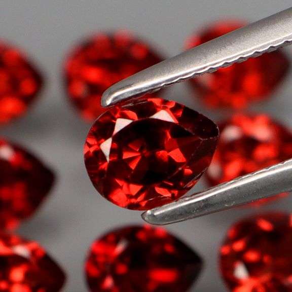 Outstanding 6.62ct pear cut high fire Mozambique Garnet set