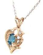 Set of 14kt Yellow gold oval blue topaz and diamond accent pendant on chain with matching earrings