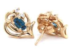Set of 14kt Yellow gold oval blue topaz and diamond accent pendant on chain with matching earrings