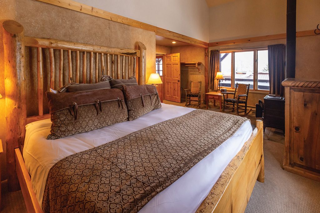 A bed in a cozy cabin.