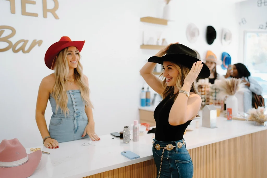 A hat tender at Rancher Hat Bar giving a customer confidence.