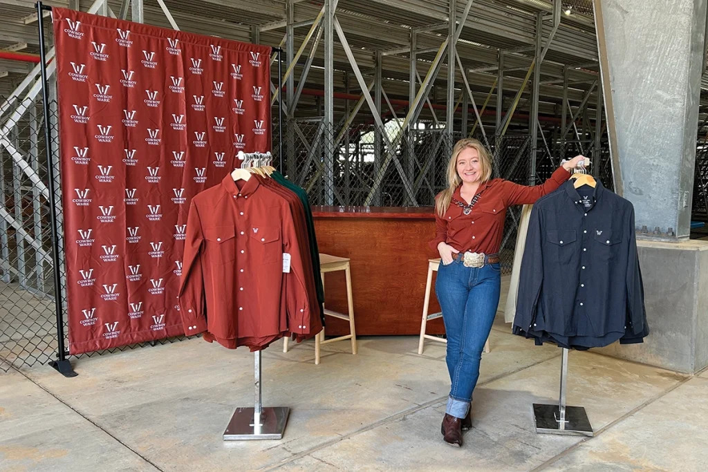 Sarah Prather, one of the featured women in Western fashion, at a Cowboy Ware booth at a stock horse show.