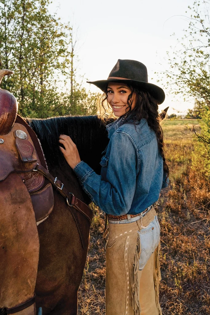 Charli Alayna poses with a horse.