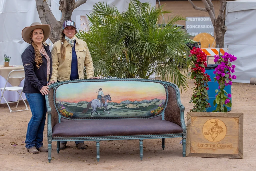 With the artist that created the work on the back of the couch, Amanda Wentz, Sierra Shores shows off the couch created for Art of the Cowgirl, where she also taught her first industry-focused workshop. 