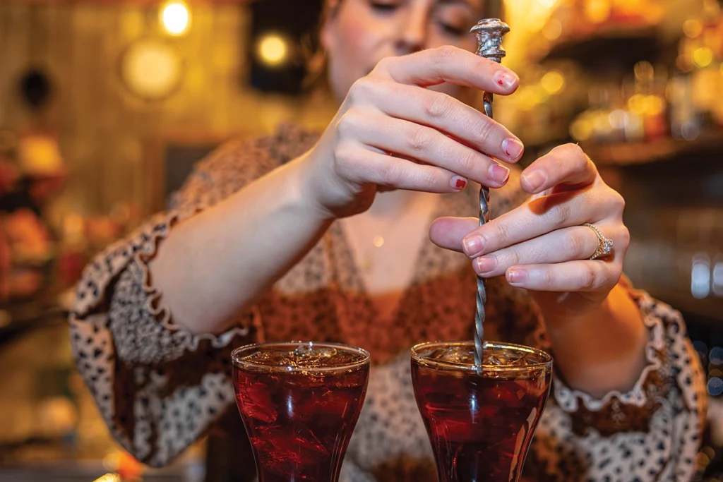 Iturriaga stirs the drink.