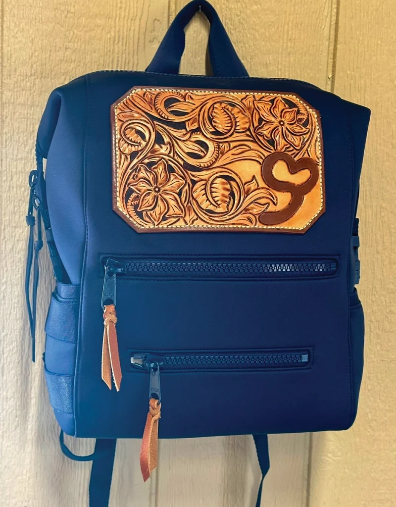 A custom diaper bag with leatherwork.