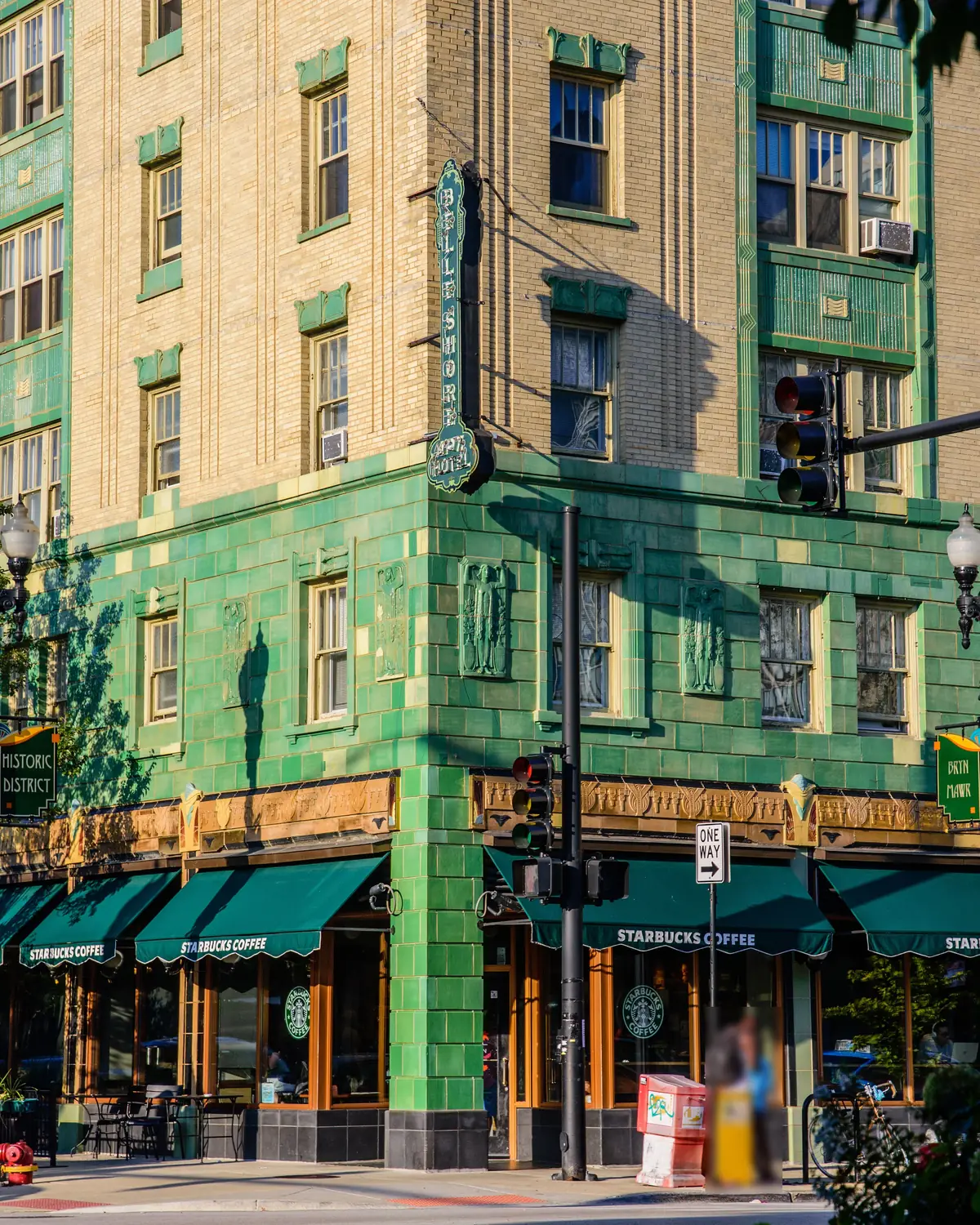 Green terra-cotta Belle Shore Apartment Hotel with storefront awnings on Bryn Mawr Avenue in Edgewater, Chicago