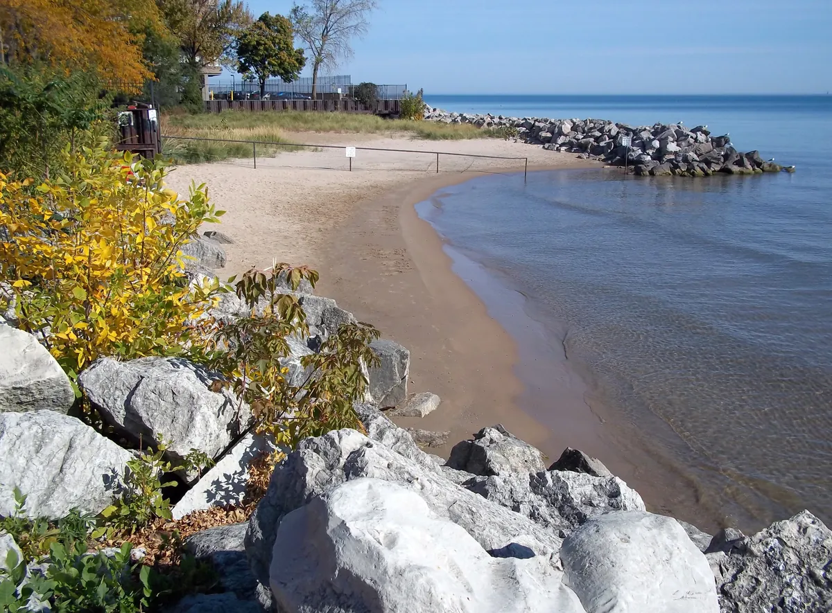 Small sandy beach and large boulders along Lake Michigan at Berger Park in Chicago's Edgewater