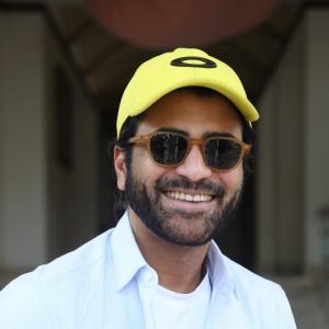 Actor Sharwanand Casual Style with Sunglasses and Yellow Cap