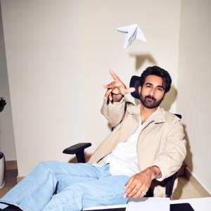 Hero Santosh Shoban Stylish and Confident Look Featuring Bold Art Background