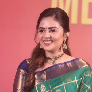 Traditional look of Sreemukhi in gold zari saree at event