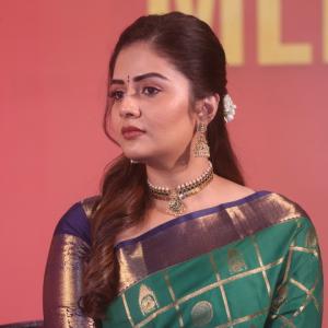Traditional look of Sreemukhi in gold zari saree at event