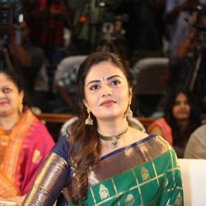 Traditional look of Sreemukhi in gold zari saree at event