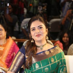 Traditional look of Sreemukhi in gold zari saree at event