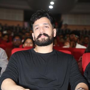 Akhil Akkineni Enjoys a Cheerful Moment at Public Event