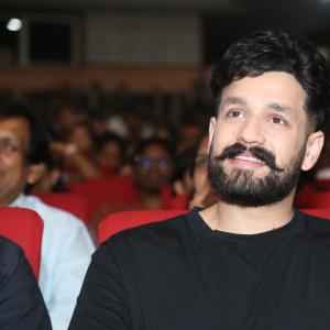 Akhil Akkineni Enjoys a Cheerful Moment at Public Event