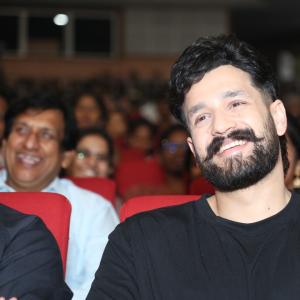 Akhil Akkineni Enjoys a Cheerful Moment at Public Event
