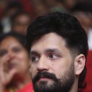 Akhil Akkineni Enjoys a Cheerful Moment at Public Event