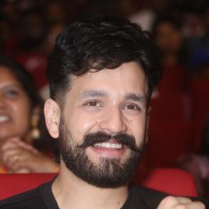 Akhil Akkineni Enjoys a Cheerful Moment at Public Event