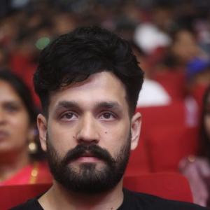 Akhil Akkineni Enjoys a Cheerful Moment at Public Event