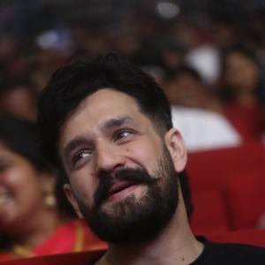 Akhil Akkineni Enjoys a Cheerful Moment at Public Event