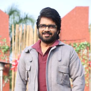 Confident Director Anil Ravipudi in Gray Jacket and Maroon Polo Shirt Look