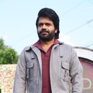 Confident Director Anil Ravipudi in Gray Jacket and Maroon Polo Shirt Look