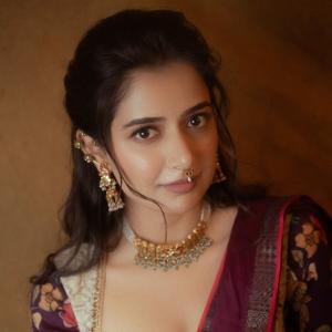 Graceful Smile of Actress Ashika Rangnath in Floral Elegance