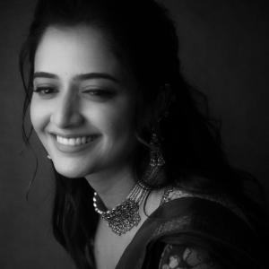 Graceful Smile of Actress Ashika Rangnath in Floral Elegance